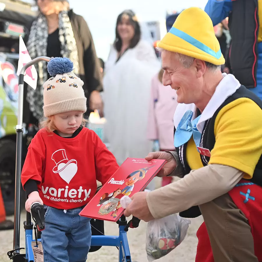 Join a Variety event - Variety bash entrant handing out present to child